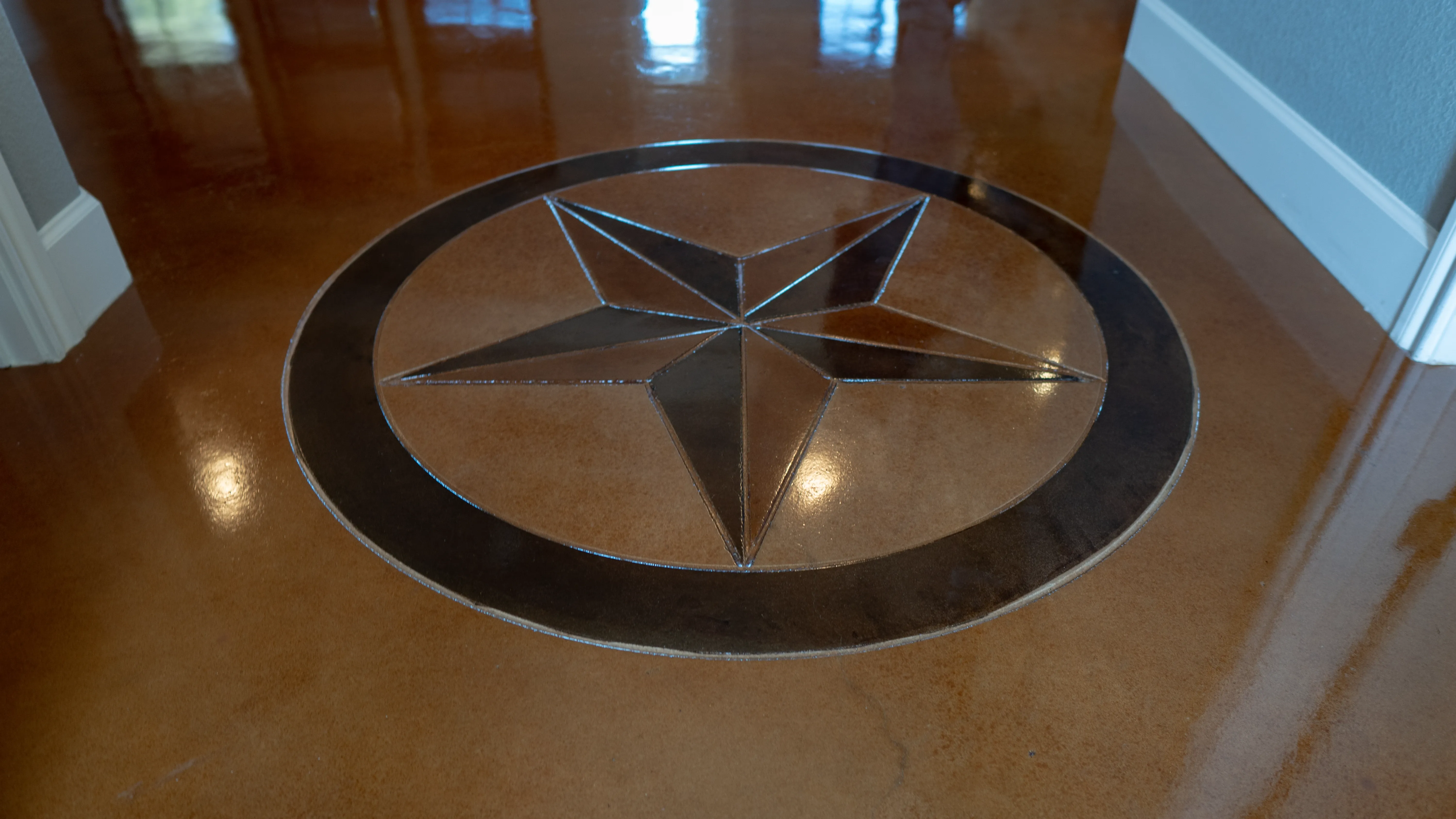 Polished concrete star inlay floor finished by The Floor Doctor in San Antonio