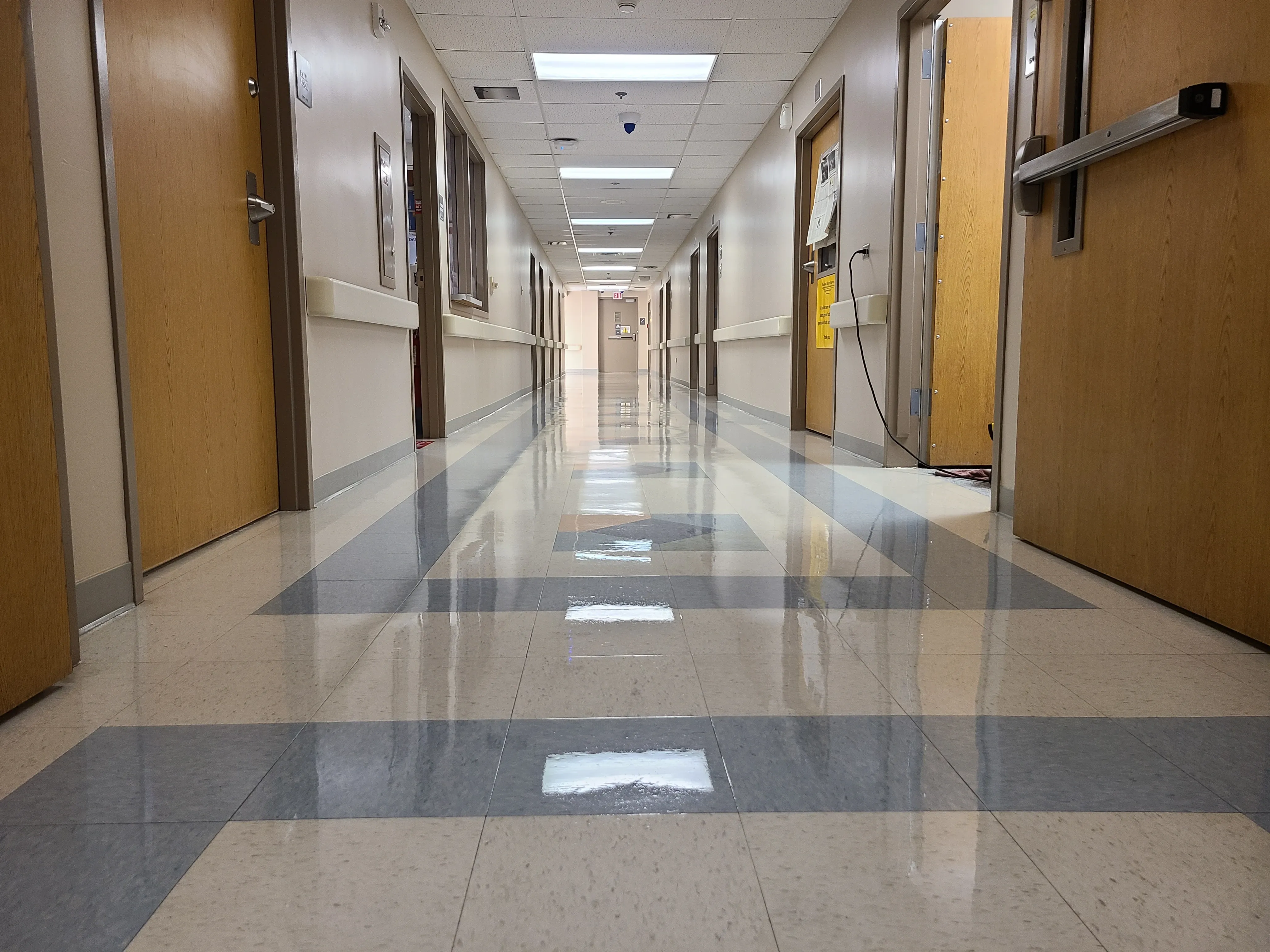 Hospital VCT corridor with a clean, freshly waxed high-gloss surface