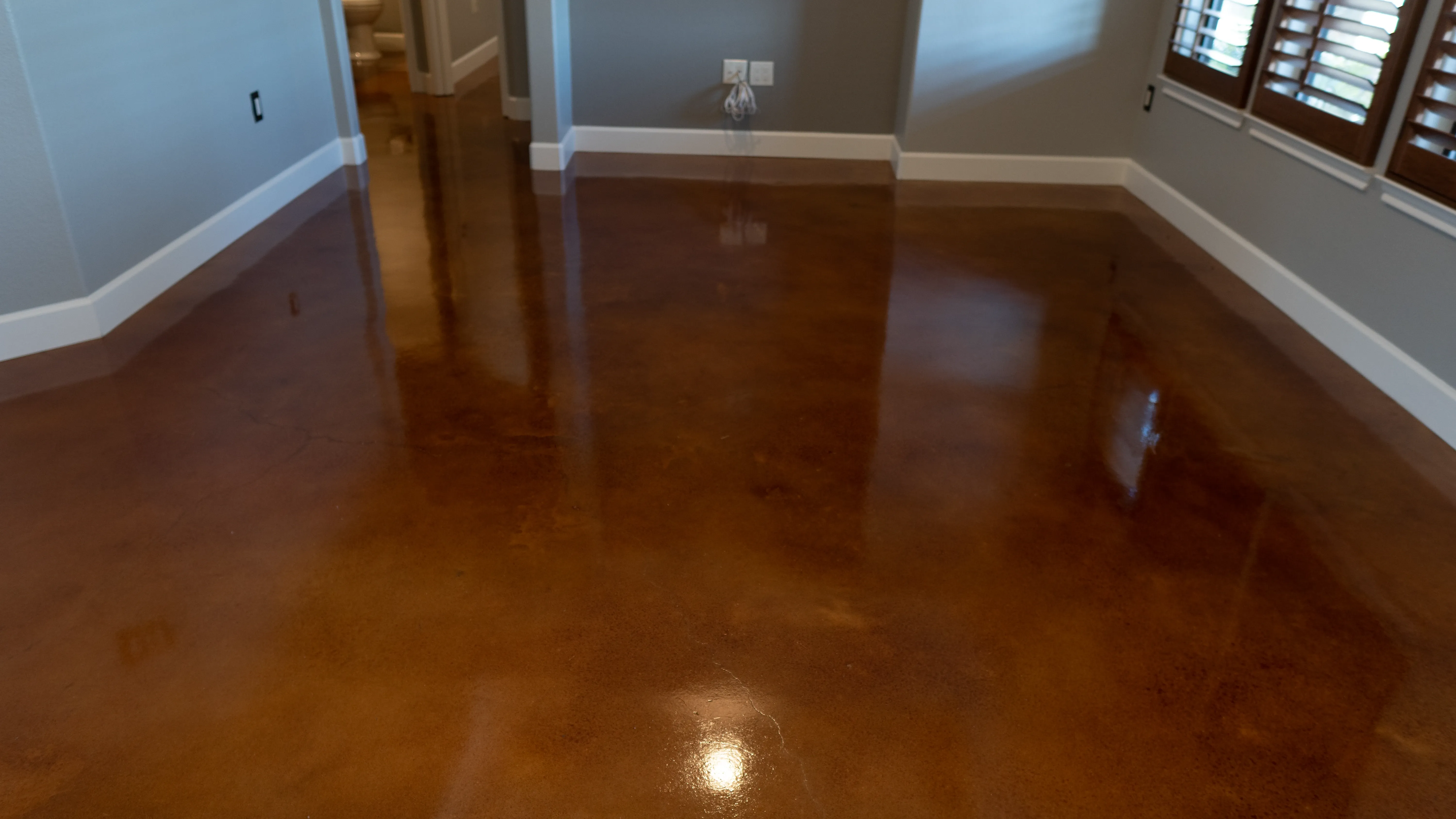 Stained concrete floor with a rich, mottled finish in warm tones