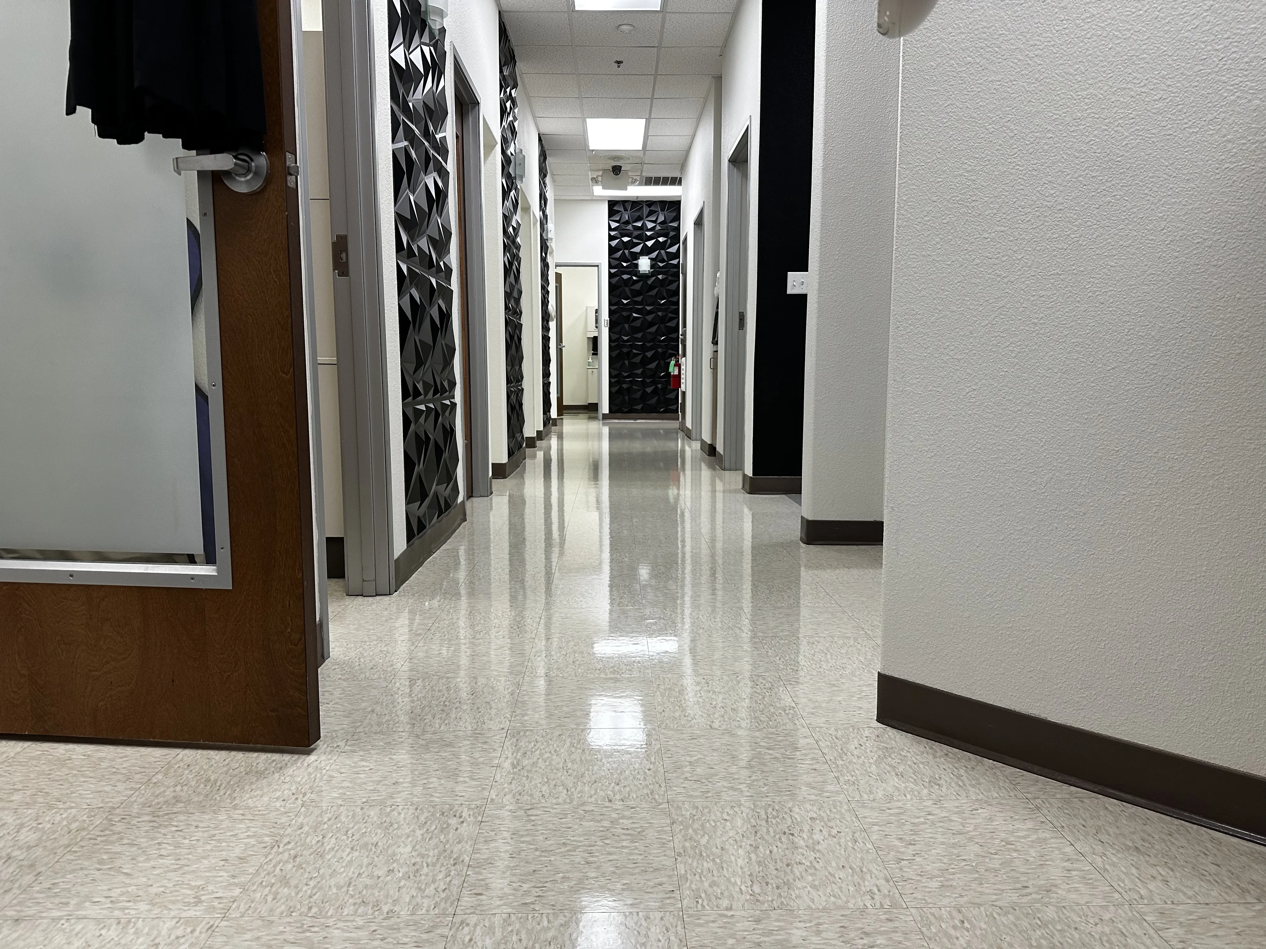 Glossy VCT corridor flooring inside a San Antonio dental practice