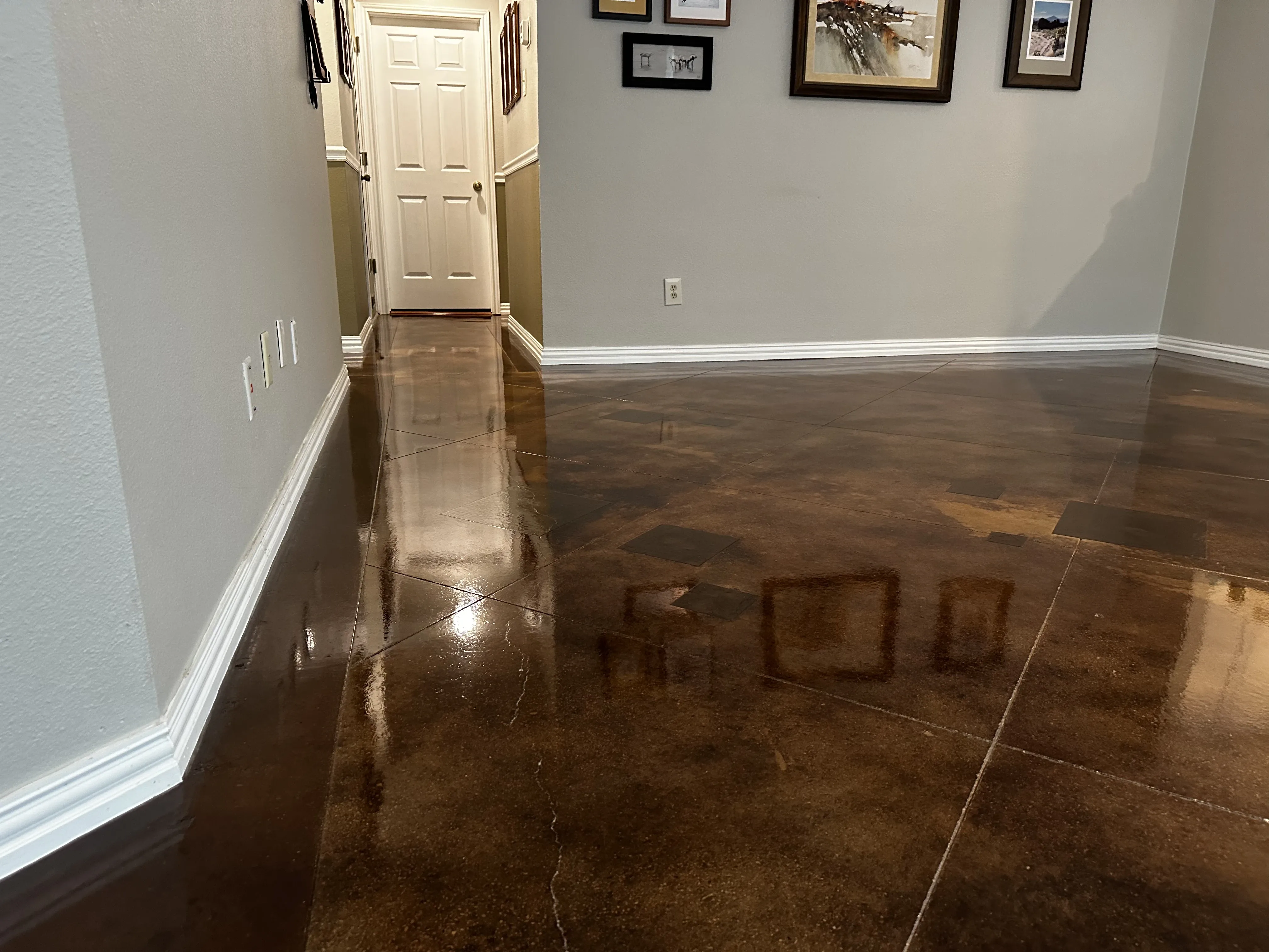 Stained concrete floor with deep earthy undertones after waxing