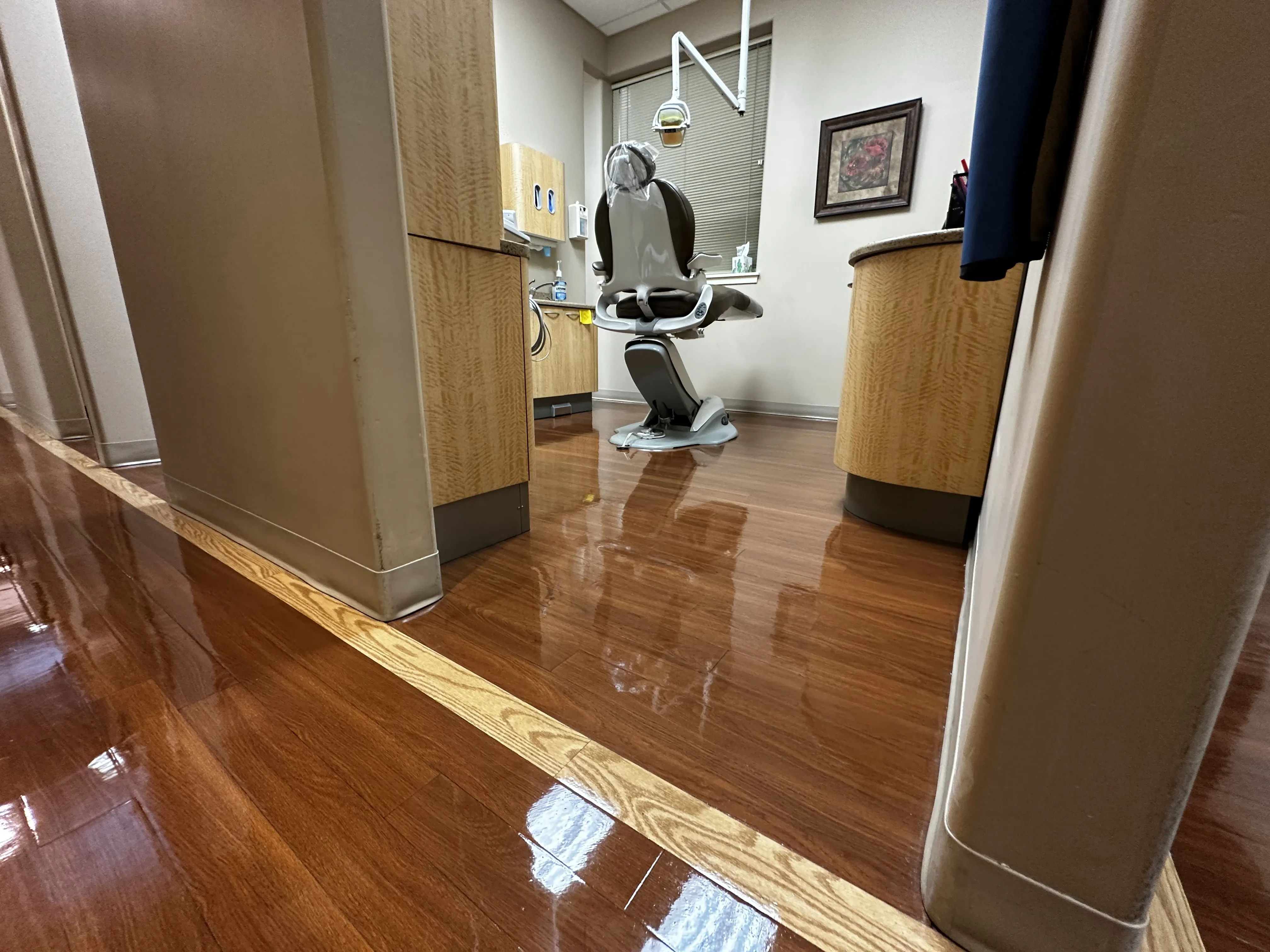Vinyl flooring in a dental office cleaned and sealed to a uniform sheen