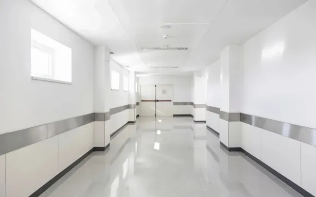 High-gloss white VCT floor refinished by The Floor Doctor